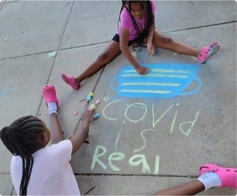 students making sidewalk art with a message