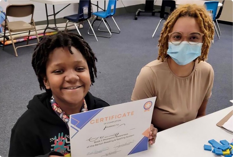 students posing with an earned certificate